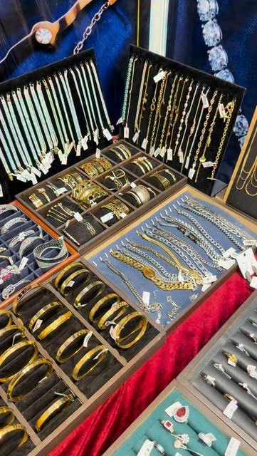 Trays of Smithllery bracelets, chains and kadas at an exhibition stall