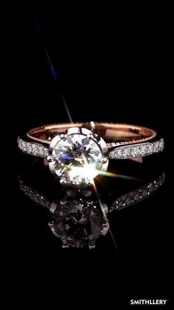 Solitaire ring catching the light on black